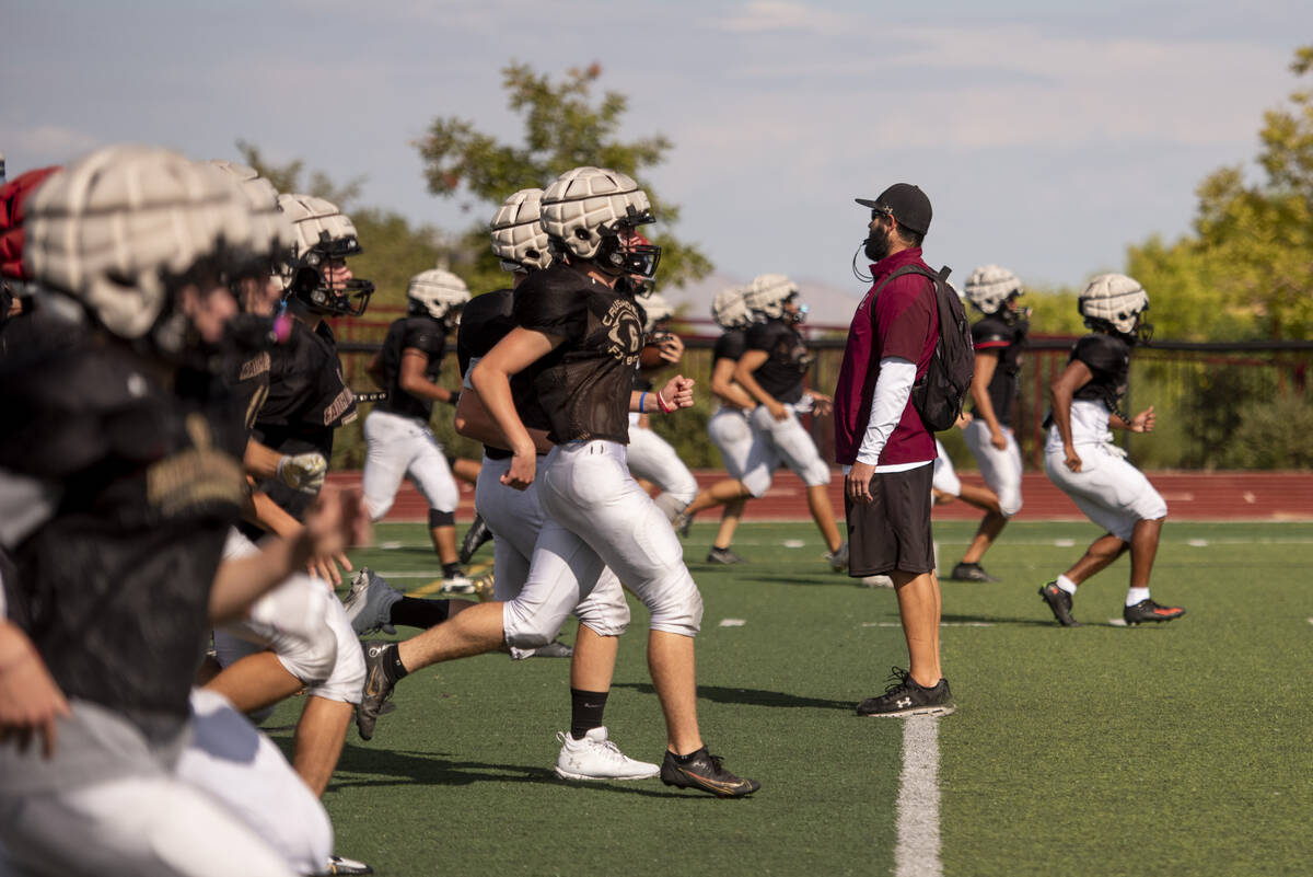 Assistant coach Jay Staggs watches a drill during practice at Faith Lutheran High School on Wed ...