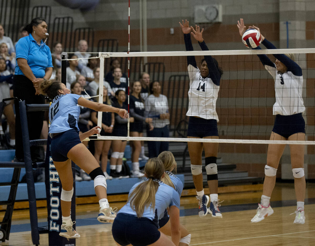 Shadow Ridge's Jyniah Sanders (14) and Elaina Smith (3) block a hit from Foothill's Maleya Mile ...