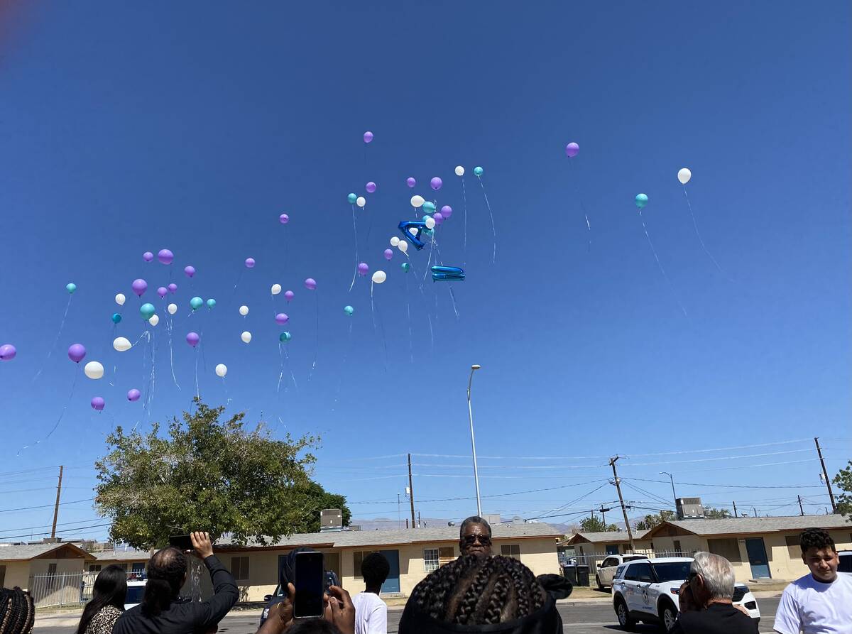 Colorful balloons are released into the sky outside the Marble Manor Community Center in honor ...