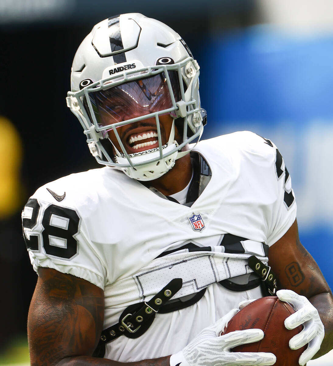 Raiders running back Josh Jacobs warms up before the start of an NFL game against the Los Angel ...