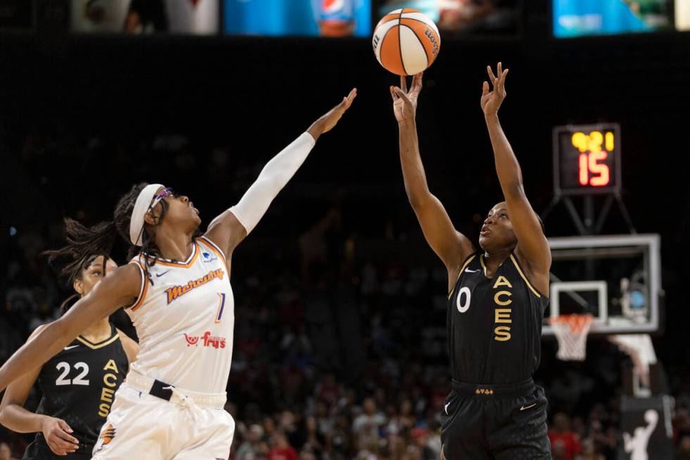 Las Vegas Aces guard Jackie Young (0) shoots against Phoenix Mercury guard Diamond DeShields (1 ...