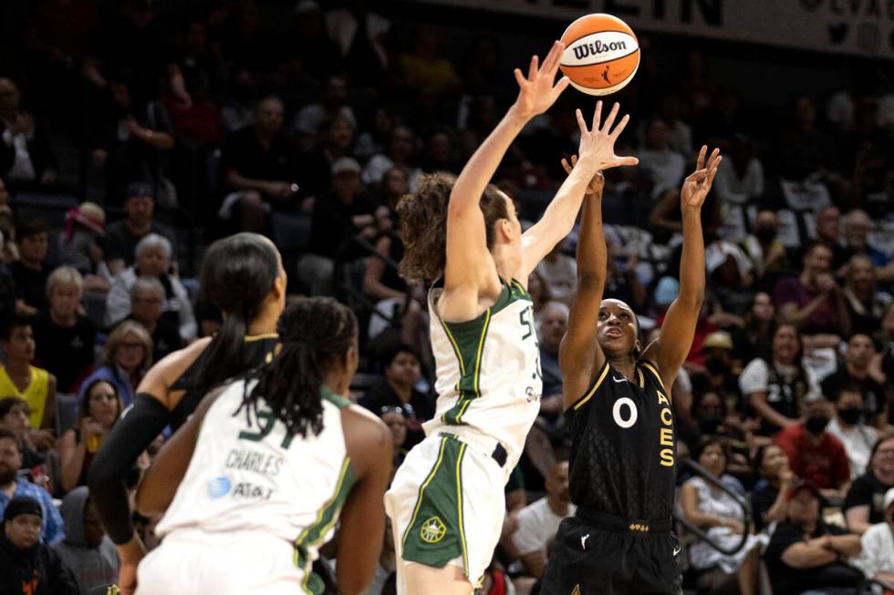 Las Vegas Aces guard Jackie Young (0) shoots against Seattle Storm forward Breanna Stewart (30) ...