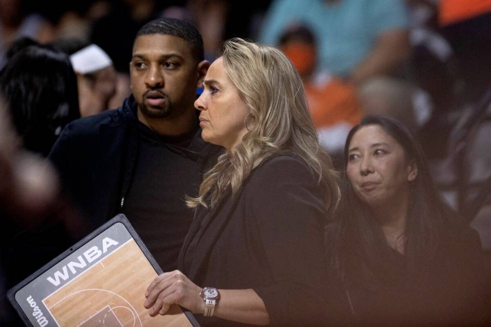 Las Vegas Aces head coach Becky Hammon, flanked by assistant coach/head of player development T ...