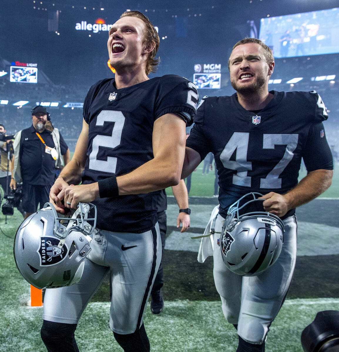 Raiders kicker Daniel Carlson (2) happily runs off the field with teammate long snapper Trent S ...