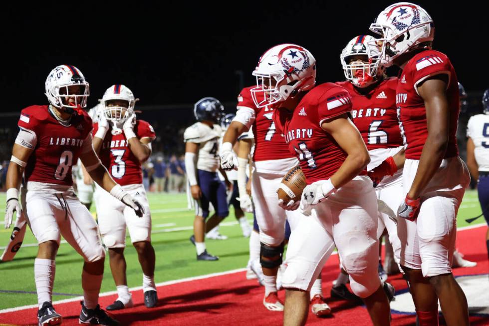 Liberty's Colin Gregorio (4) reacts after a touchdown in the first half of a football game agai ...