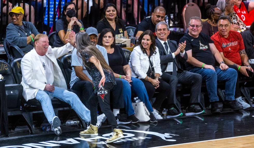 Raiders owner Mark Davis gets a "high five" from a High Rollers dancer during the sec ...