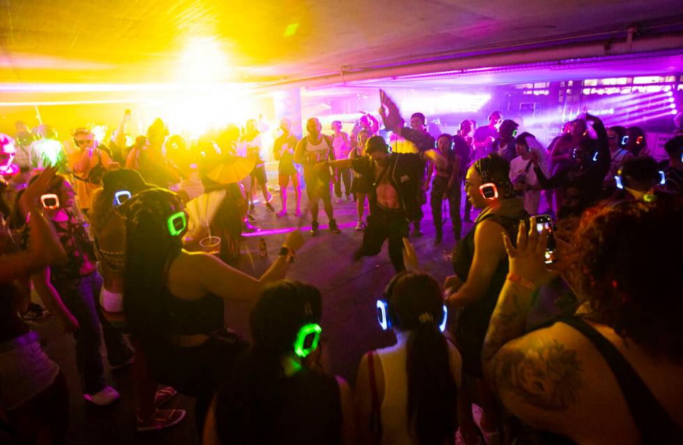 Attendees dance as Wizdumb performs in a silent disco at the 7-Eleven Brainfreeze Garage during ...