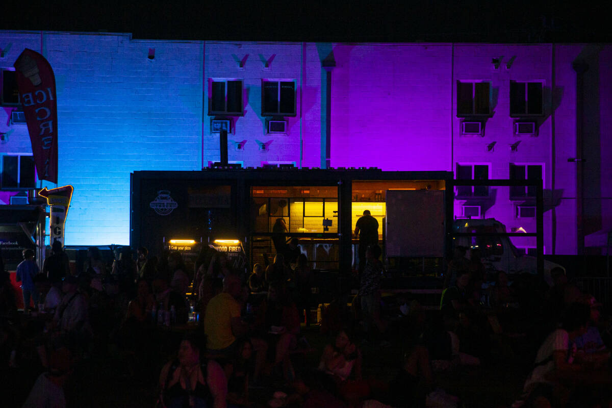 A worker is silhouetted in a food truck during the first day of the Life is Beautiful festival ...