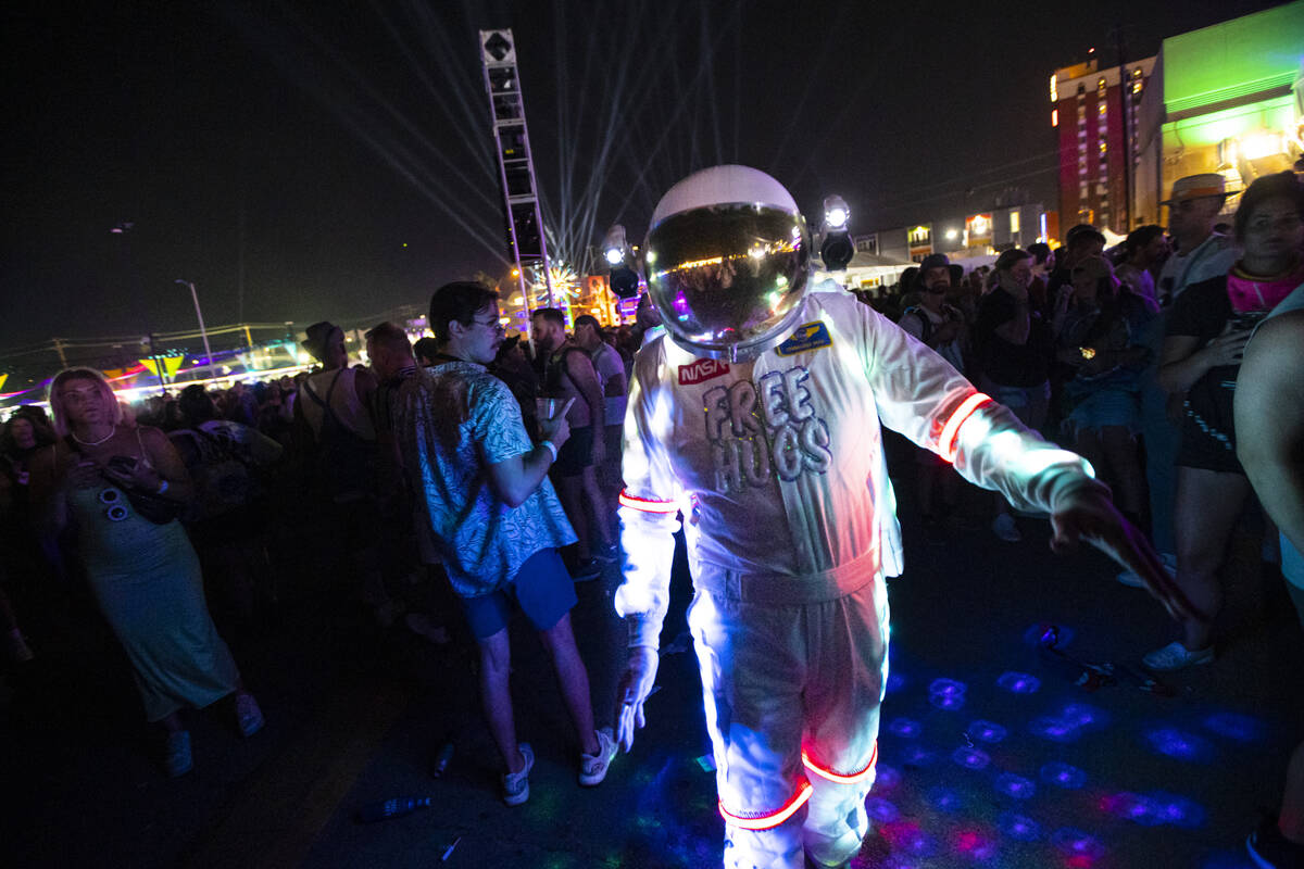 An attendee dressed up in a space suit dances as Cage the Elephant performs during the first da ...
