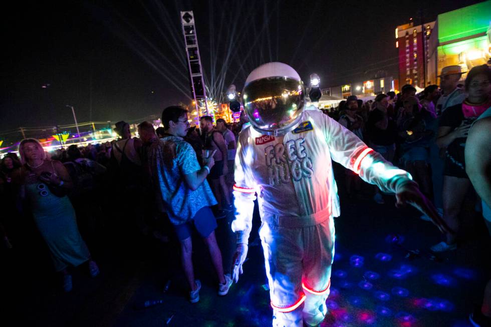 An attendee dressed up in a space suit dances as Cage the Elephant performs during the first da ...
