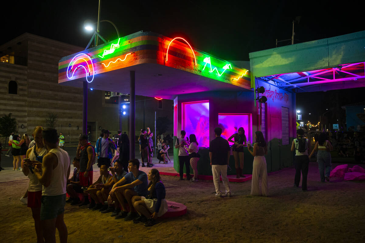 Attendees take a break by the former 1931 gas station at Fremont and 8th Streets during the fir ...
