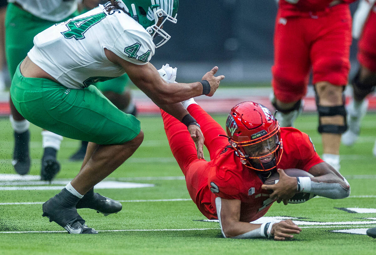 UNLV Rebels quarterback Doug Brumfield (2) dives for a few more yards beside North Texas Mean G ...