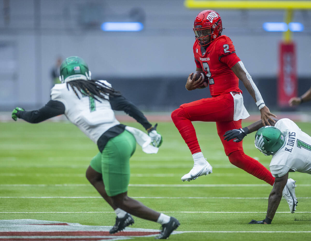 UNLV Rebels quarterback Doug Brumfield (2) deflects a tackle attempt by North Texas Mean Green ...