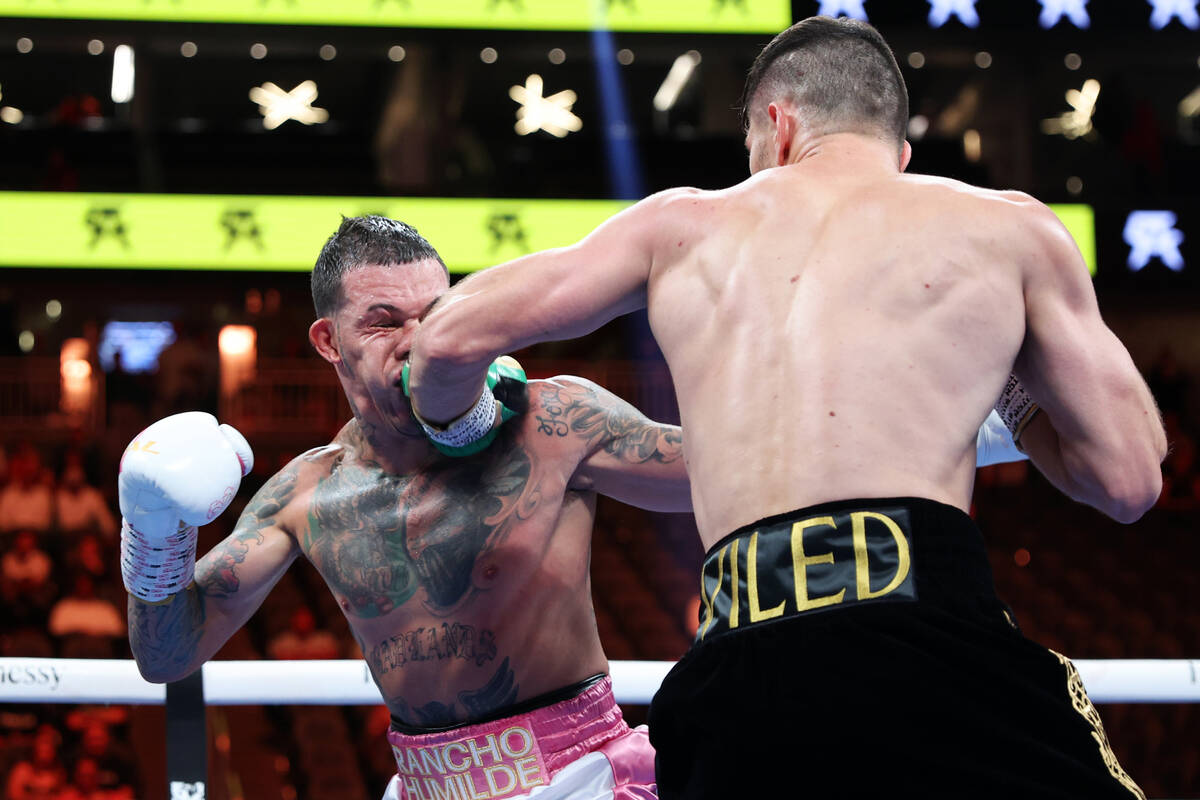 Ali Akhmedov, right, connects a punch against Gabriel Rosado, in the third round of a super mid ...