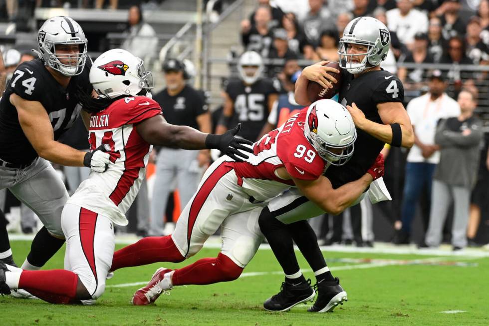 Las Vegas Raiders quarterback Derek Carr (4) is sacked by Arizona Cardinals defensive end J.J. ...