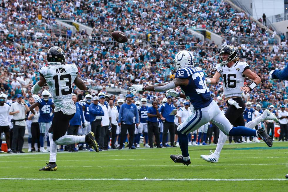 Jacksonville Jaguars quarterback Trevor Lawrence (16) throws a pass for a touchdown to wide rec ...