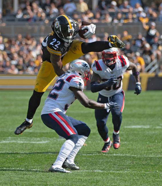 Pittsburgh Steelers running back Najee Harris (22) jumps over New England Patriots safety Devin ...