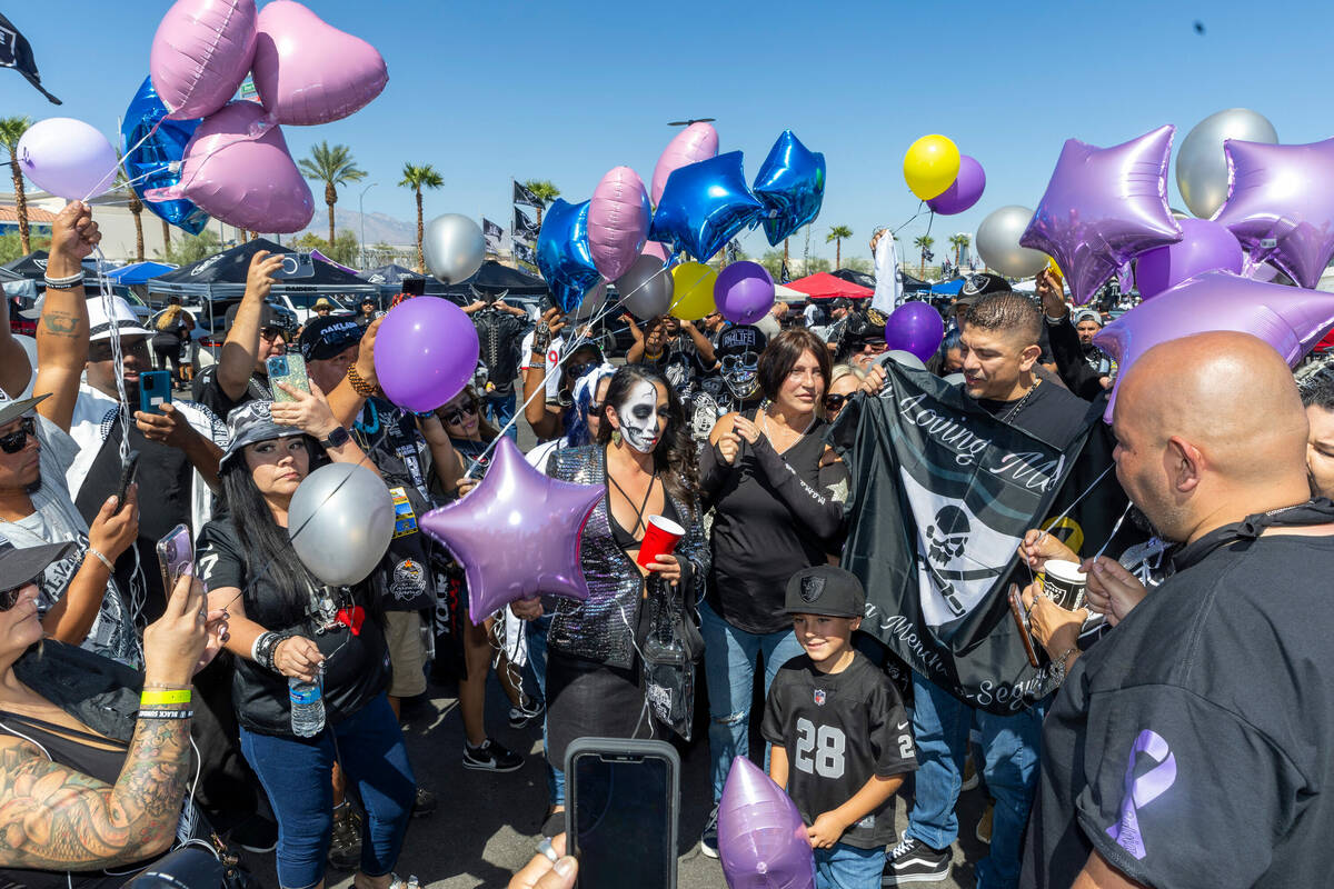 Family and friends of deceased Raiders fan Sylvia Menchaca-Segura gather in the parking lot dur ...