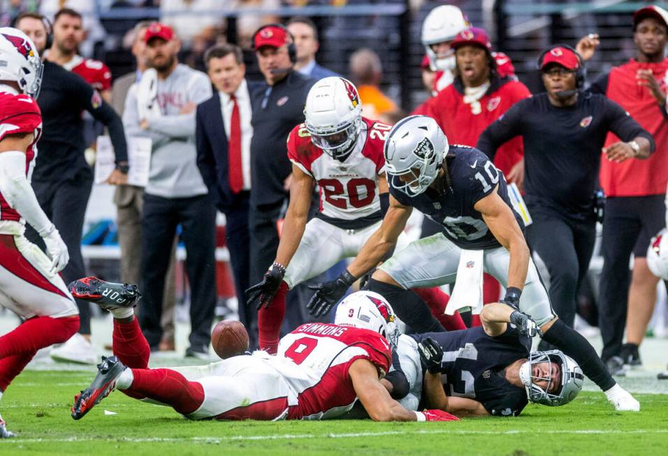 Raiders wide receiver Hunter Renfrow (13) fumbles the ball after a big hit from Arizona Cardina ...