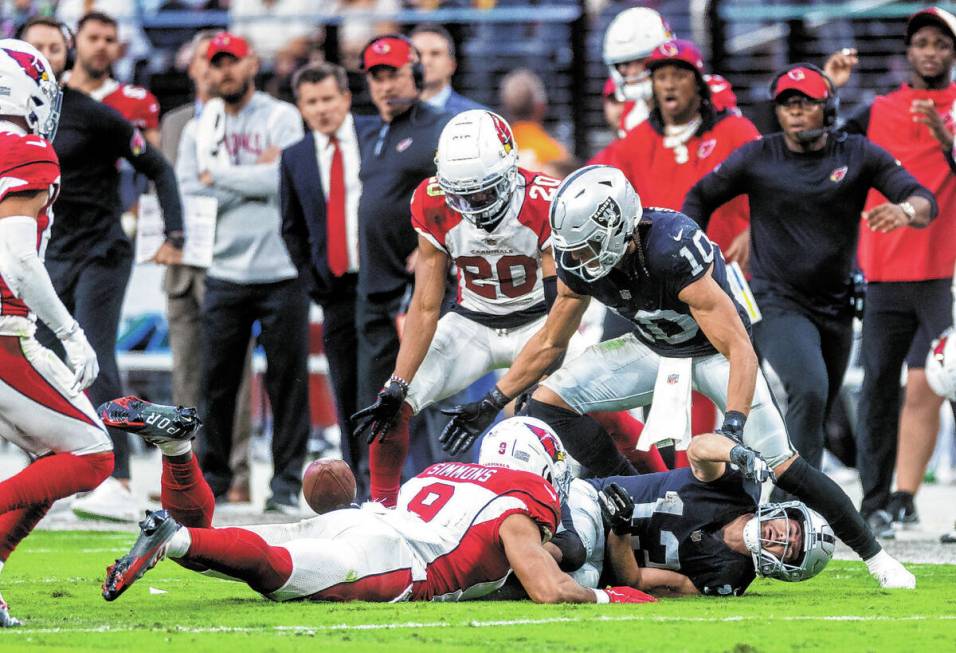 Raiders wide receiver Hunter Renfrow (13) fumbles the ball after a big hit from Arizona Cardina ...