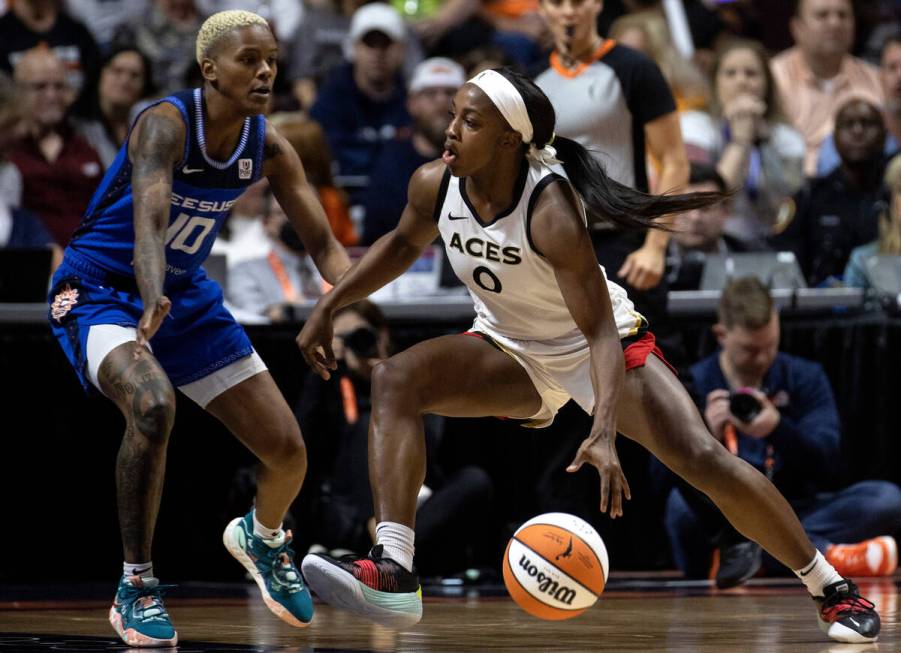 Las Vegas Aces guard Jackie Young (0) drives around Connecticut Sun guard Courtney Williams (10 ...