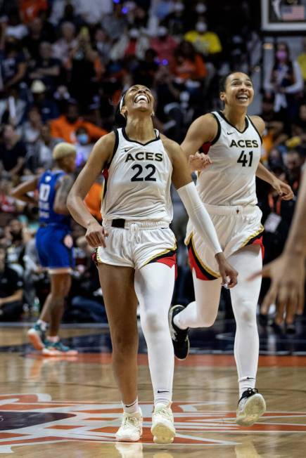 Las Vegas Aces forward A'ja Wilson (22) and center Kiah Stokes (41) celebrate as they win Game ...