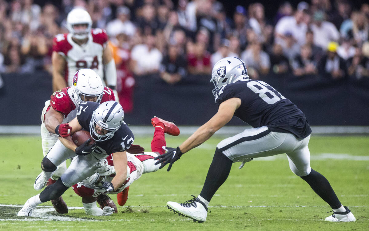 Raiders wide receiver Hunter Renfrow (13) fights for more yards as Arizona Cardinals linebacker ...
