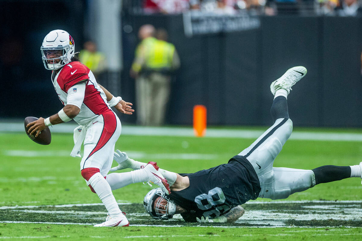 Arizona Cardinals quarterback Kyler Murray (1) evades a diving sack attempt by Raiders defensiv ...