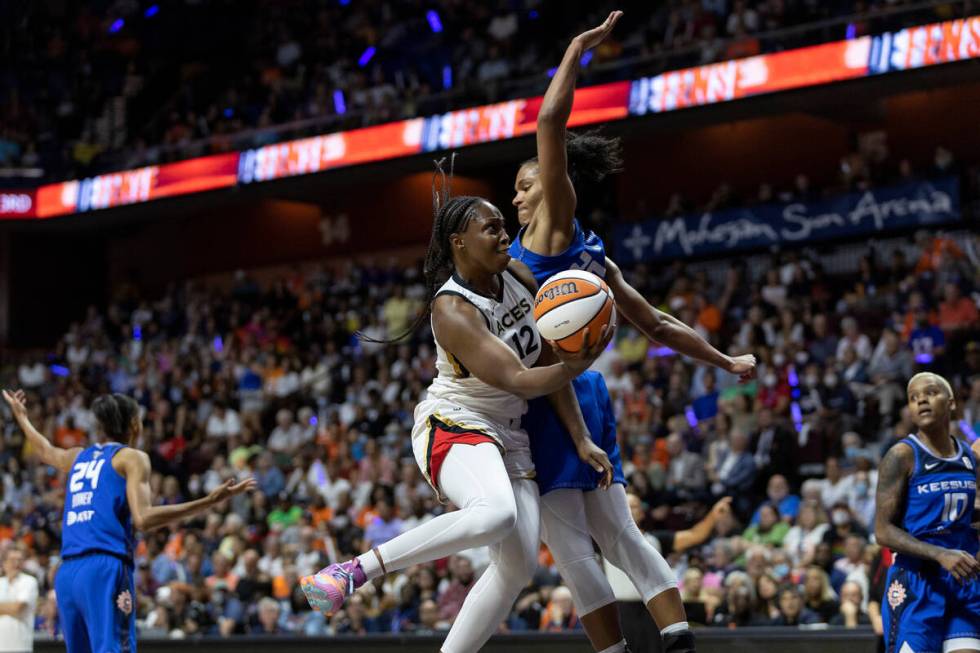 Las Vegas Aces guard Chelsea Gray (12) shoots against Connecticut Sun forward Alyssa Thomas (25 ...