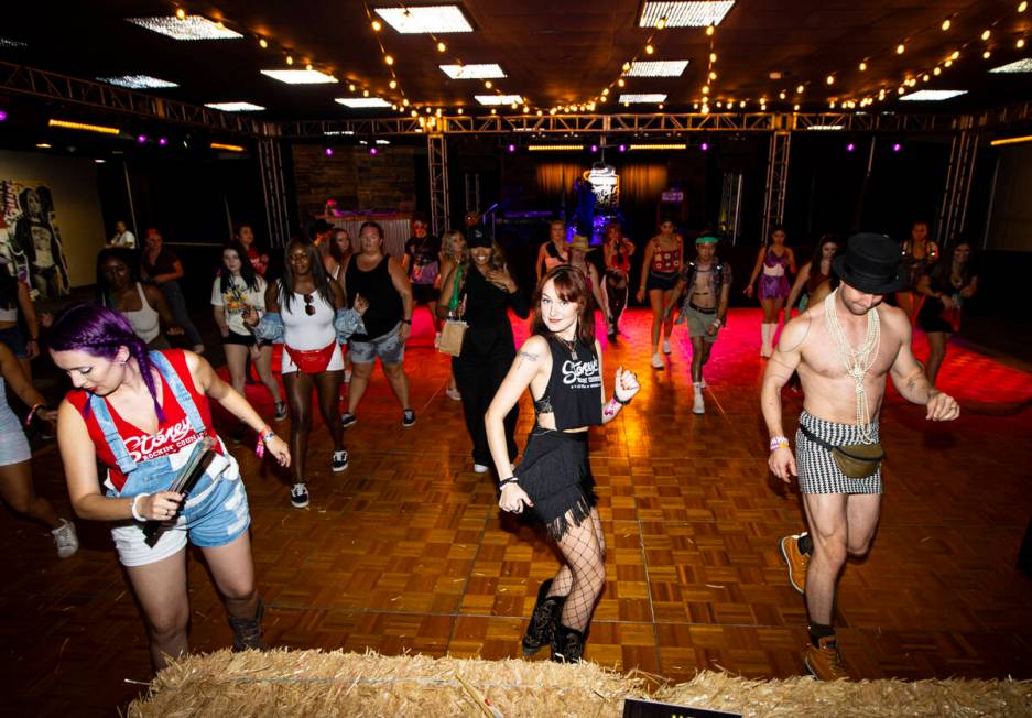 Attendees line dance at the Western Country Club during the Life is Beautiful festival on Sunda ...