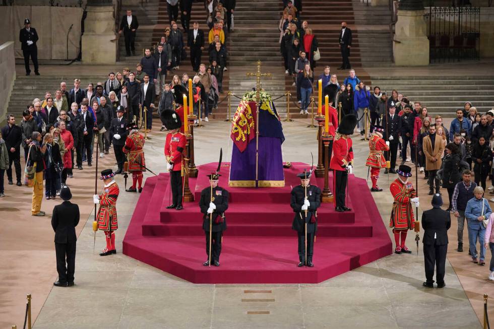 The final members of the public pay their respects at the coffin of Queen Elizabeth II, draped ...