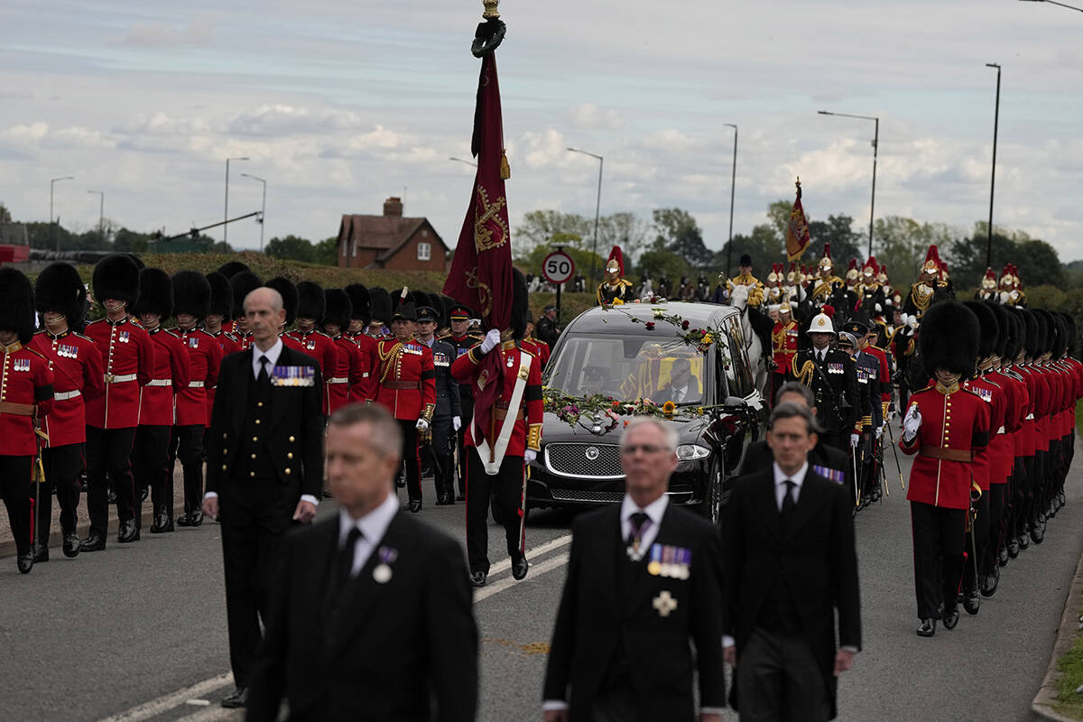 Flowers cover the hearse carrying the coffin of Queen Elizabeth II as it arrives on the Albert ...
