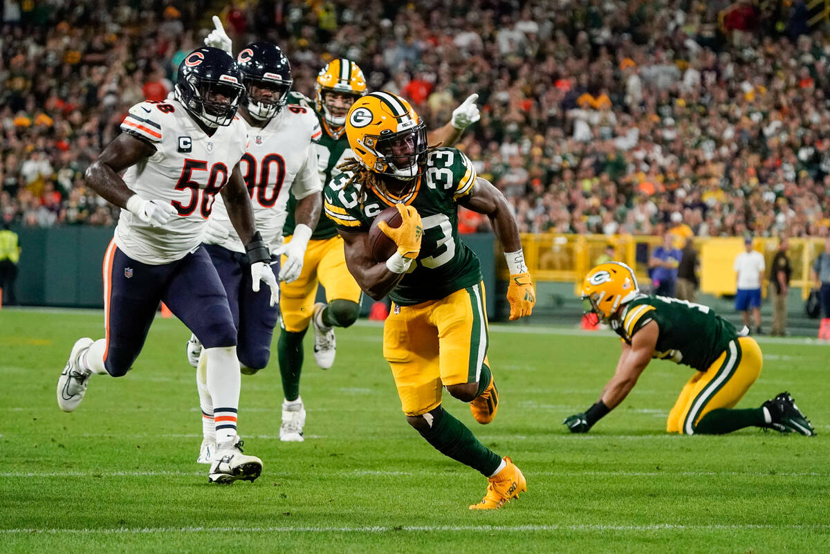 Green Bay Packers' Aaron Jones runs for a touchdown during the first half of an NFL football ga ...