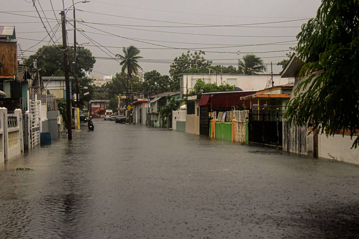 A flooded road is seen during the passage of hurricane Fiona in Villa Blanca, Puerto Rico, on S ...