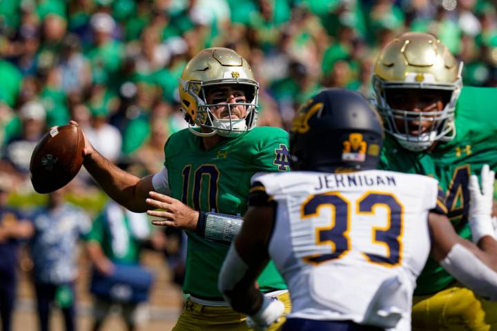 Notre Dame quarterback Drew Pyne (10) throws against California during the first half of an NCA ...