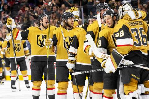 Golden Knights players celebrate after beating the Washington Capitals 4-3 in overtime during a ...