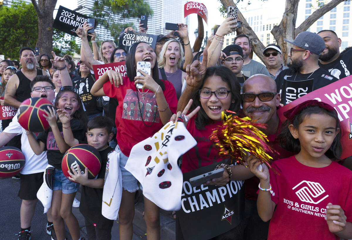 Fans watch as the Las Vegas Aces pass by during the team's WNBA Championship victory parade on ...