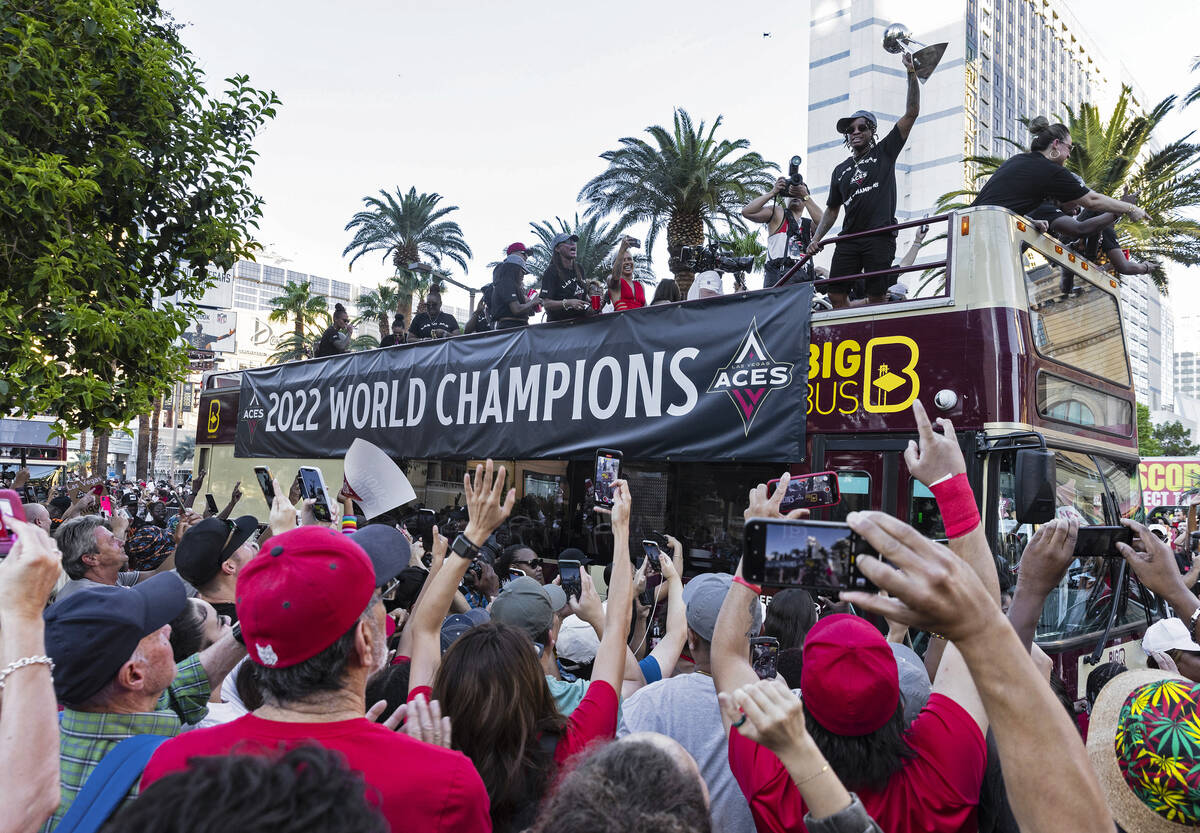 Fans watch as the Las Vegas Aces pass by during the team's WNBA Championship victory parade on ...