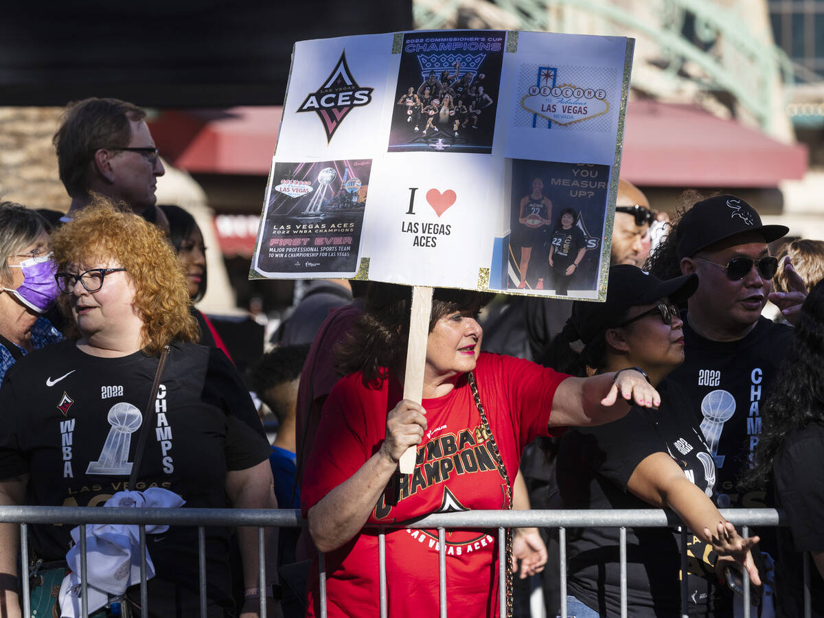 Fans wait to watch the Las Vegas Aces pass by during the team's WNBA Championship victory parad ...