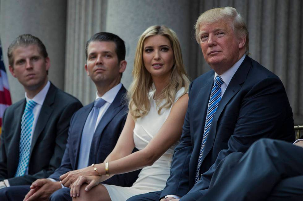 FILE - Donald Trump, right, sits with his children, from left, Eric Trump, Donald Trump Jr., an ...