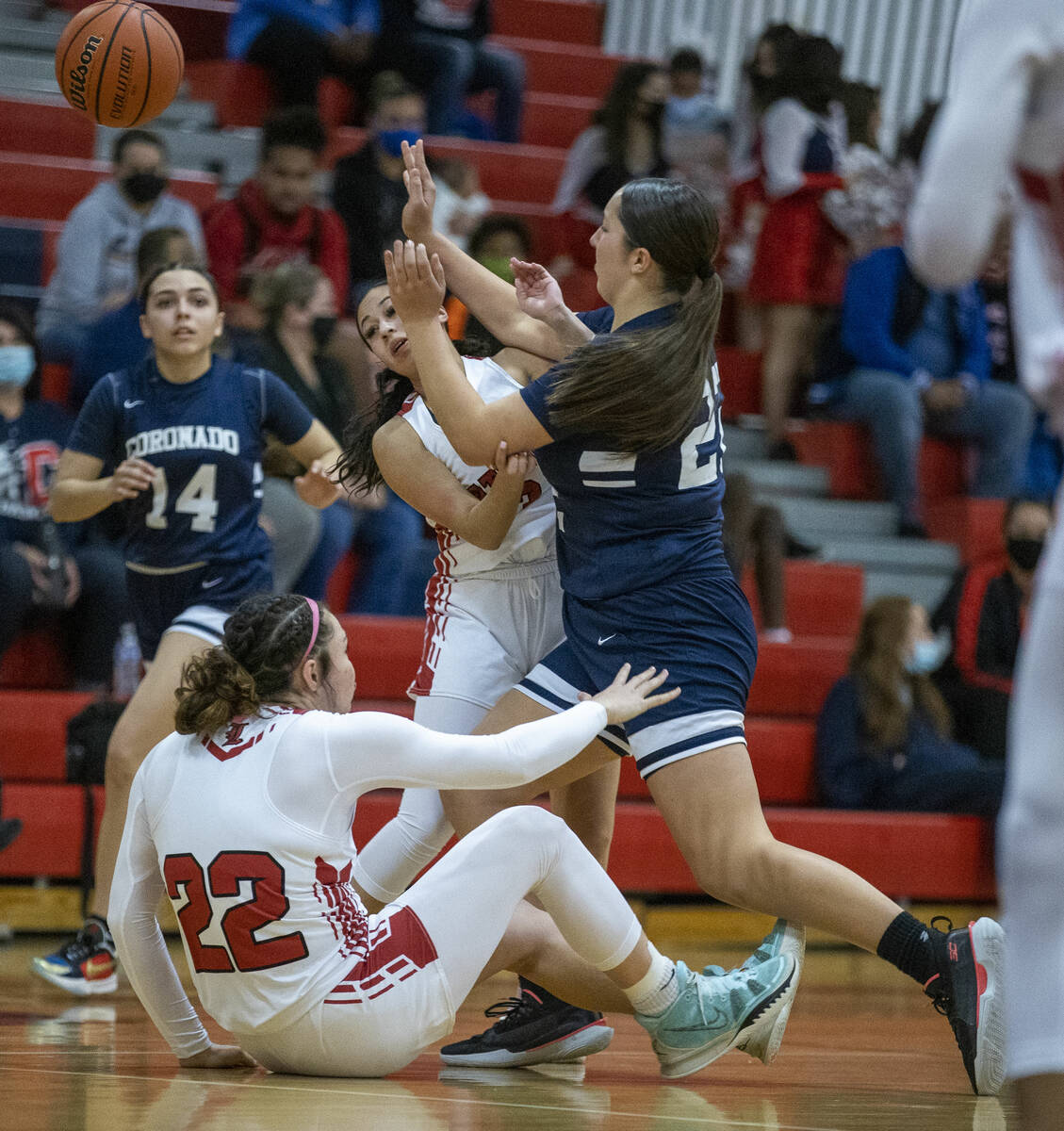 Coronado forward Ashtyn Wick (22) passes the ball after colliding with Liberty forwards Ali'a M ...