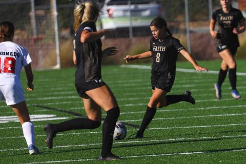 Faith Lutheran's Olivia Stark (8) kicks the ball under pressure from Coronado during a soccer g ...