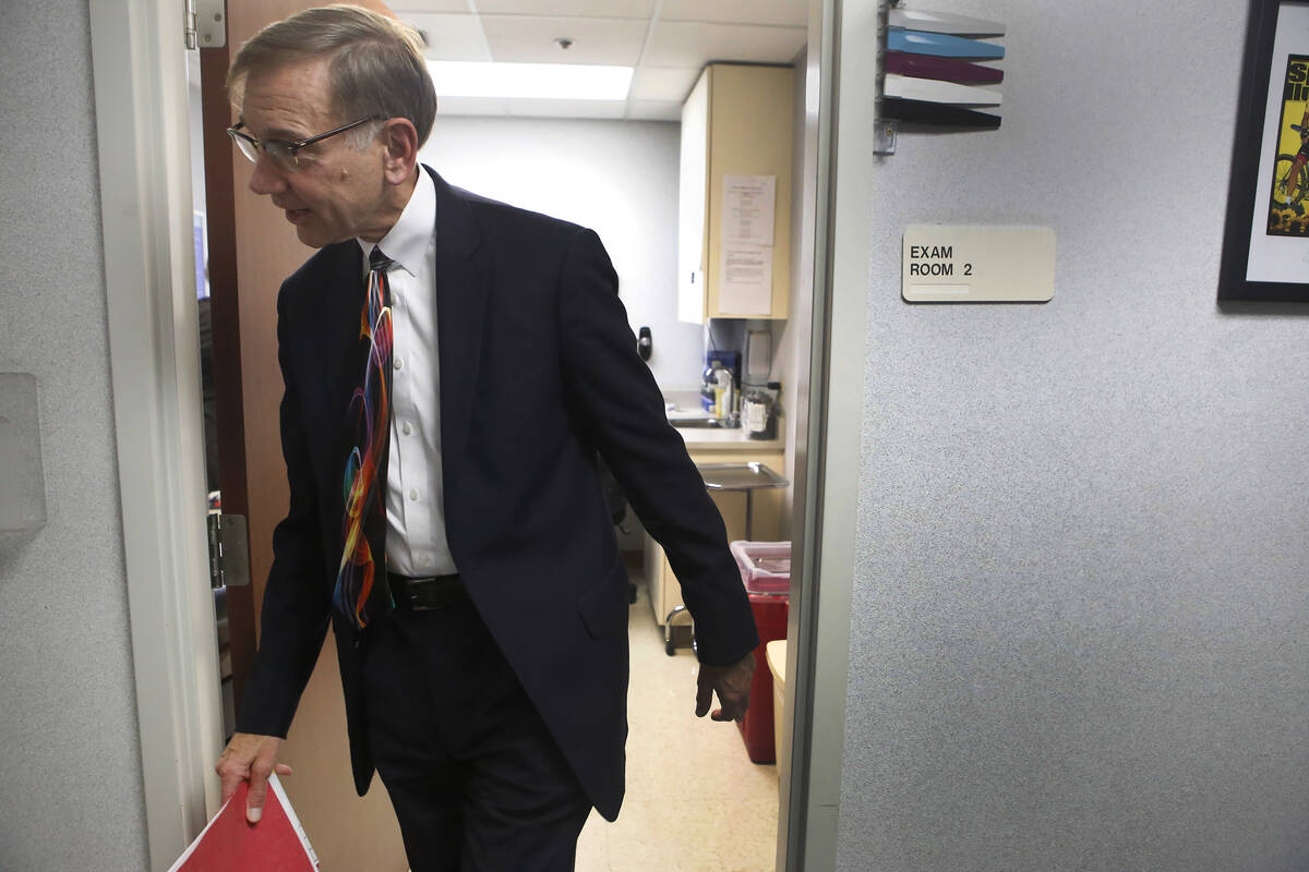 Dr. Nicholas Vogelzang walks out of a room after an appointment at the Comprehensive Cancer Cen ...