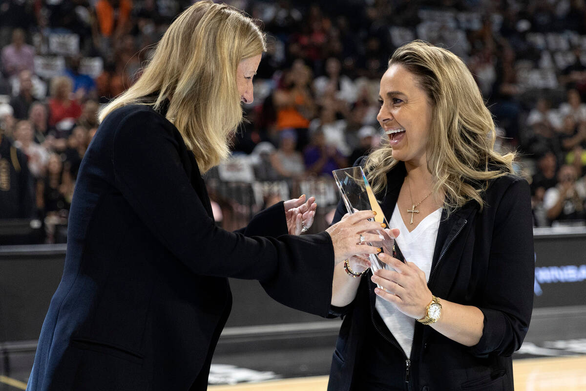 Las Vegas Aces head coach Becky Hammon accepts her WNBA Coach of the Year trophy from WNBA Comm ...