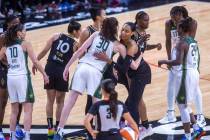 Las Vegas Aces and Seattle Storm players greet each other on the court before the first half of ...