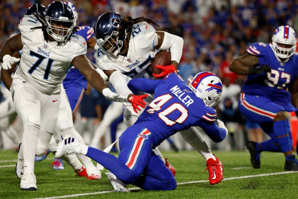 Tennessee Titans running back Derrick Henry (22) is tackled by Buffalo Bills linebacker Von Mil ...