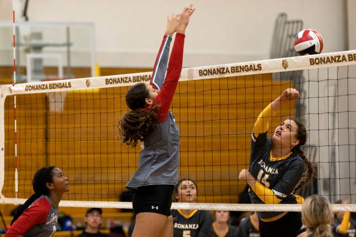 Arbor View’s Willow Watson, center, jumps to kill while Bonanza’s Hannah Judkins ...