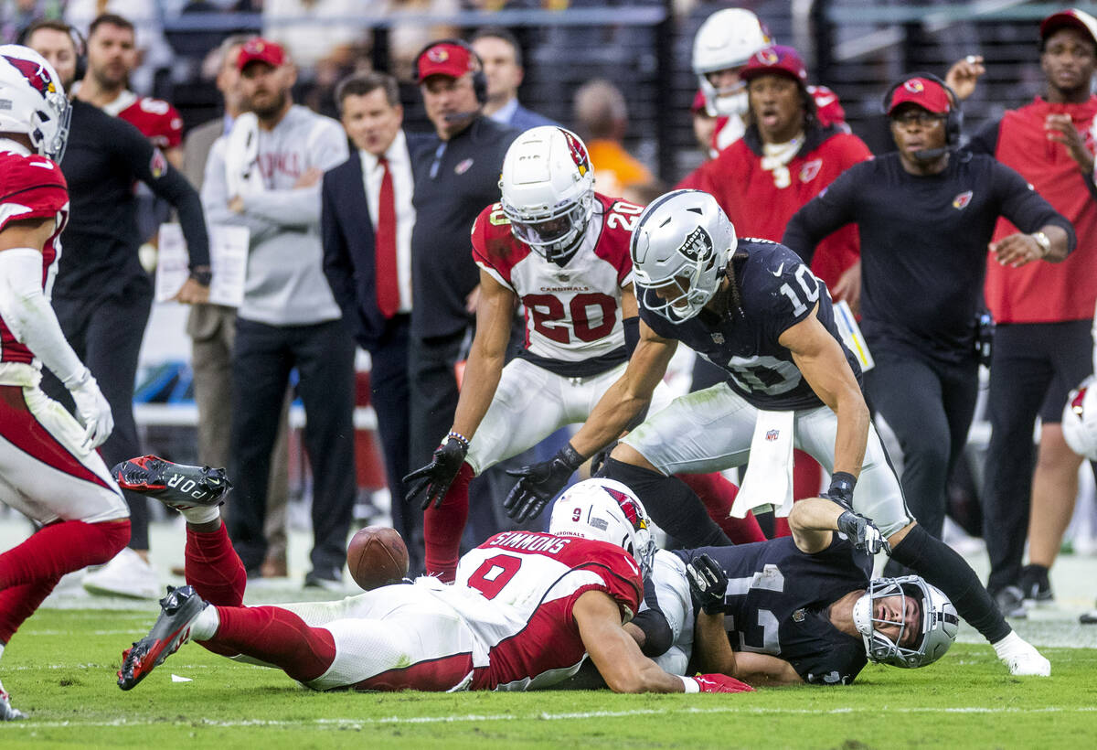 Raiders wide receiver Hunter Renfrow (13) fumbles the ball after a big hit from Arizona Cardina ...