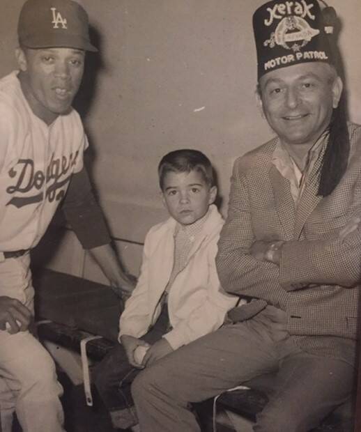 Former Las Angeles Dodgers base-stealing great Maury Wills, left, and a young Brady Exber, cent ...