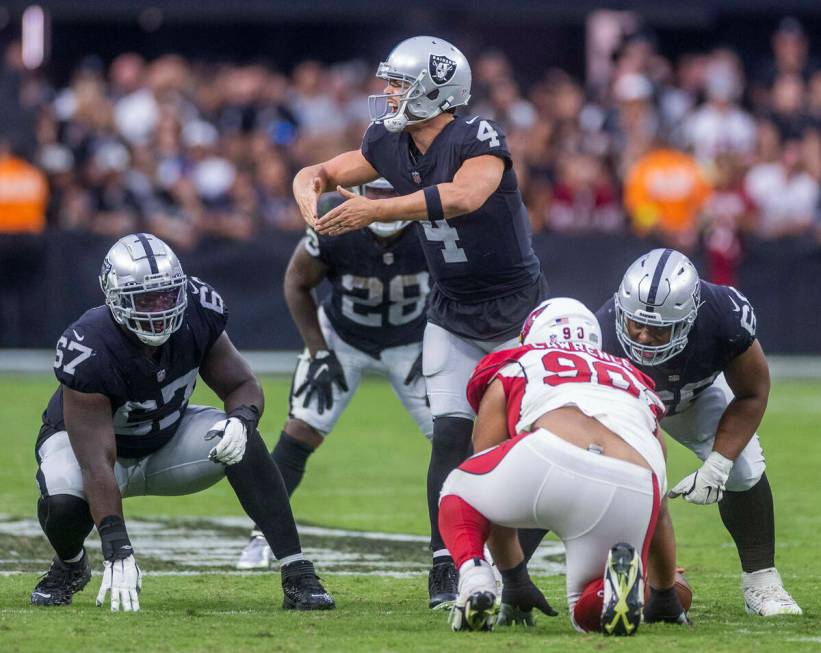 Raiders quarterback Derek Carr (4) calls a play versus Arizona Cardinals during overtime in the ...
